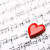 close up of sheet music with heart